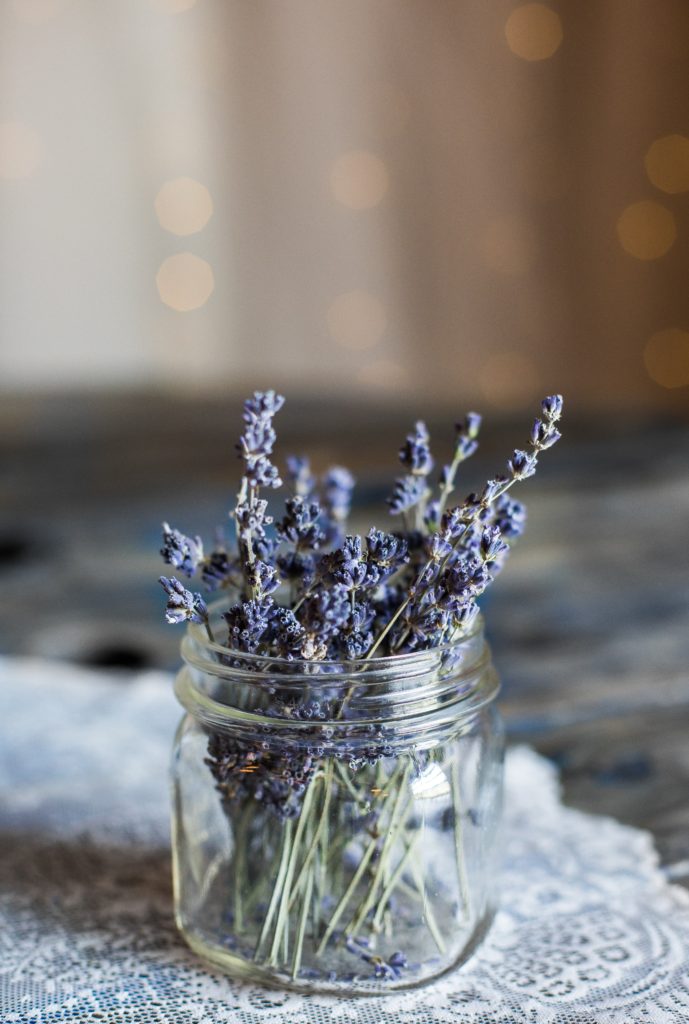 Several sprigs of dried lavender neatly arranged in a glass mason jar on the counter. Lavender is used for natural meopause relief in many blends.