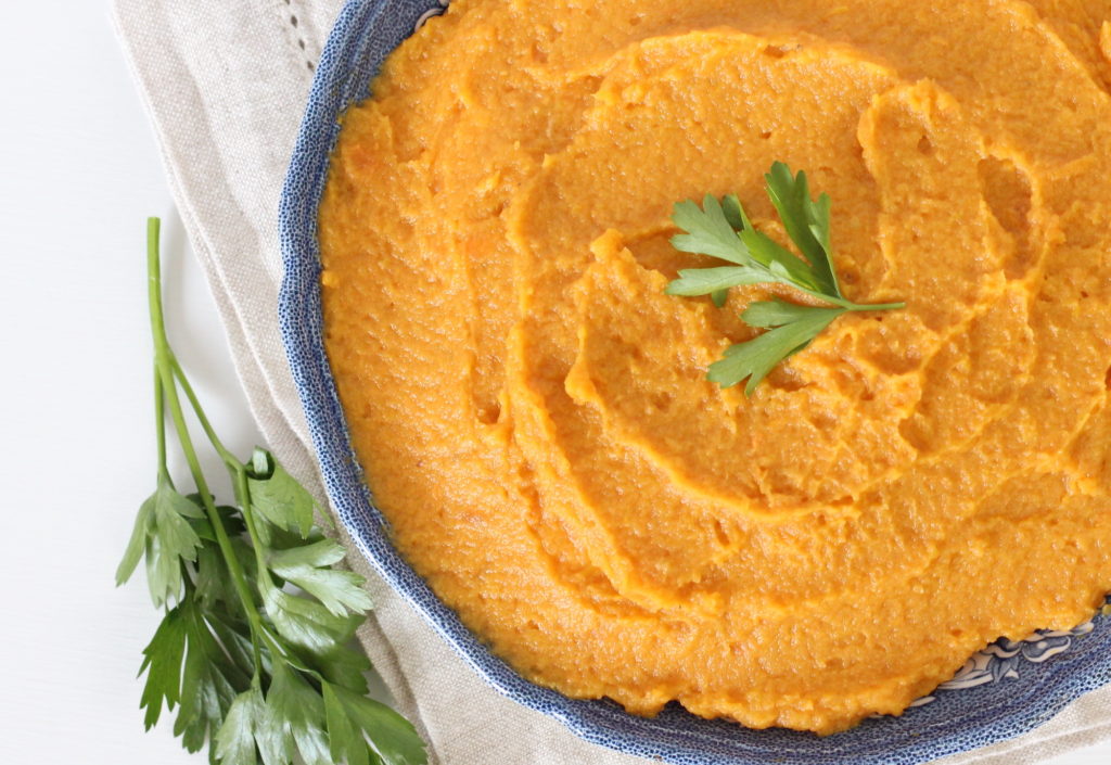 overhead view of mashed sweet potatoes without brown sugar in a blue bowl