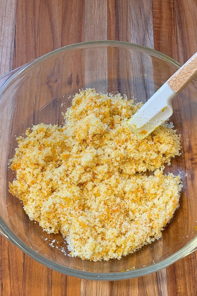 Fresh orange zest rubbed into granulated sugar for cranberry orange bread