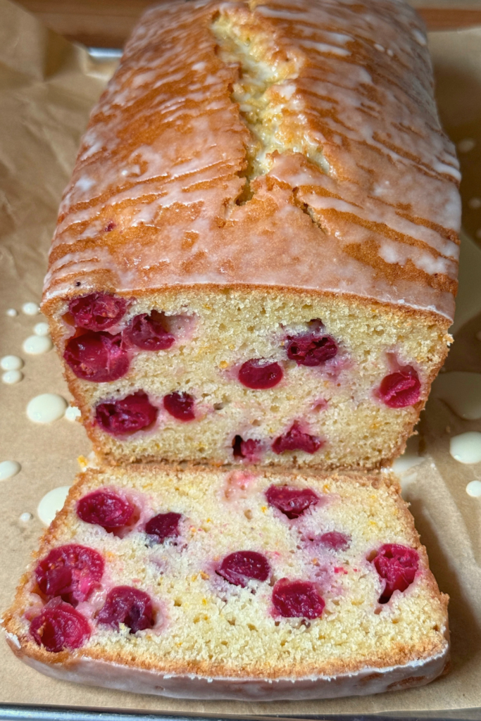 Slices of cranberry orange bread showing whole cranberries throughout the loaf