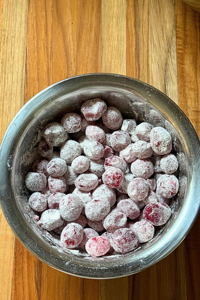 Fresh cranberries lightly coated in flour before adding to bread batter